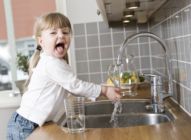 Girl with kitchen faucet